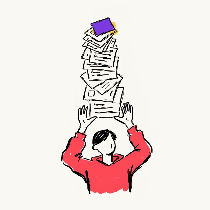 A creator holding up a tall wobbling stack of files with both hands